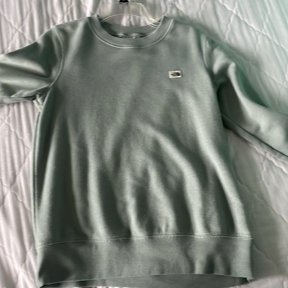 The north face crew neck its like a blue green made of cotton